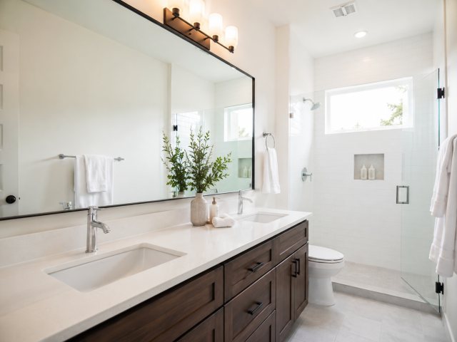 Clean commercial restroom surfaces and fixtures after janitorial service